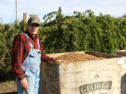 Ridgefield farmer Rob Baur checks to see if the bin filled with recently harvested hazelnuts is ready to ship out.