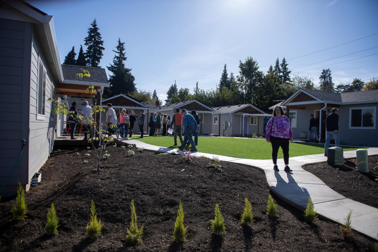 Visitors tour the new Community Roots Collaborative O Street property, which opens next week to local families. Community leaders said the property symbolizes a new beginning for people exiting homelessness.