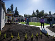 Visitors tour the new Community Roots Collaborative O Street property, which opens next week to local families. Community leaders said the property symbolizes a new beginning for people exiting homelessness.