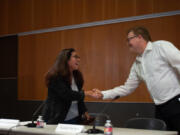 Rep. Monica Jurado Stonier, left, and challenger Russell Barber, candidates for the 49th District House, Position 2, shake hands at the beginning of their segment of a recent League of Women Voters forum.