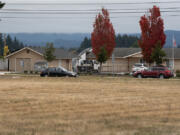 A motorist passes by vacant lots off state Highway 503 where developers have proposed a 13-building industrial development.