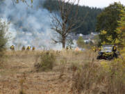 Fire crews conducting a prescribed burn Tuesday at Lacamas Prairie spread out into two lines, a burn line and a hold line, once a test fire is finished. A test fire is necessary to ensure temperature, humidity, wind and other conditions are met before the controlled burn can move forward.