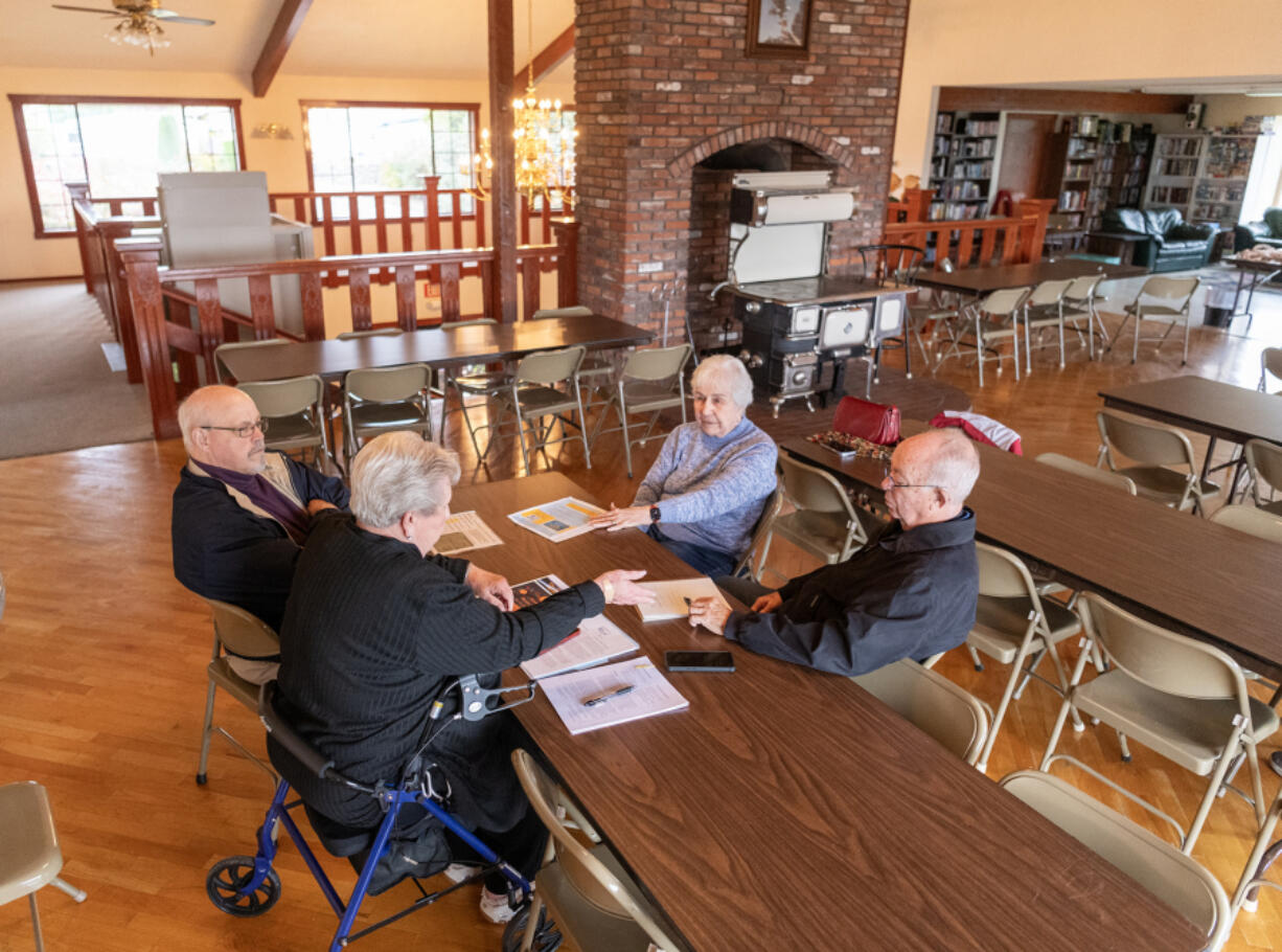 *LEADOPTION* Vista Del Rio interim boardmembers Gloria Titus, clockwise from top, Tom Kent, Deb Swope and Rick Seekins hold a board meeting Tuesday. Residents are trying to buy the park, which has been put up for sale by the property owner. .