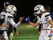 Seton Catholic junior Kolten Gesser (13) and senior Joe Callerame (1) shake hands after a touchdown during a 49-12 win over Kalama on Friday.