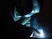 LEADOPTION Senior George Kinerk, 17, of Fort Vancouver High School takes part in Friday&rsquo;s SteelDays welding competition at Clark College.