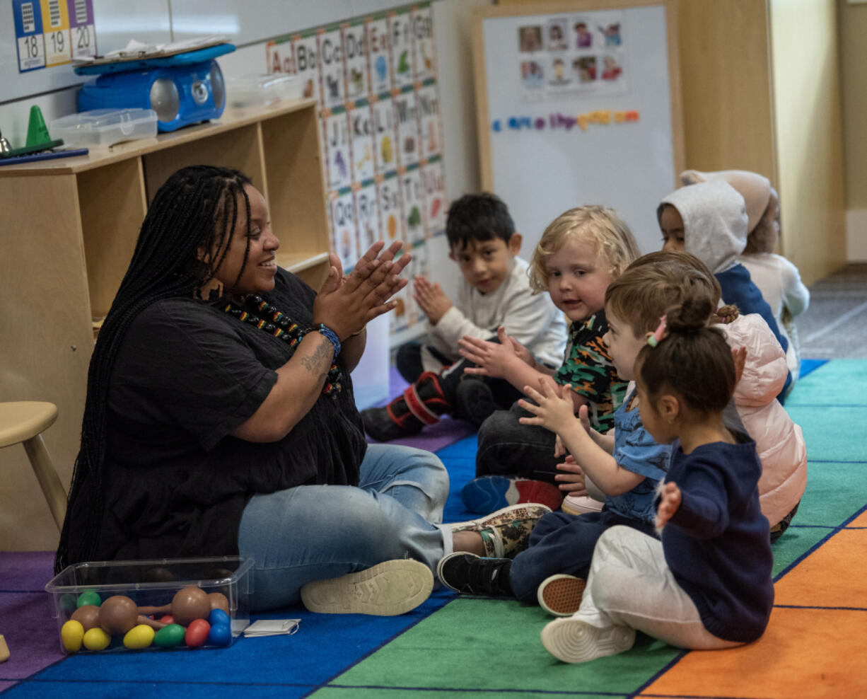 Teacher Tamara Harris, left,  works with students Thursday at Ruby Bridges Early Learning Center.