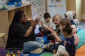 Teacher Tamara Harris, left,  works with students Thursday at Ruby Bridges Early Learning Center.