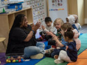 Teacher Tamara Harris, left,  works with students Thursday at Ruby Bridges Early Learning Center.