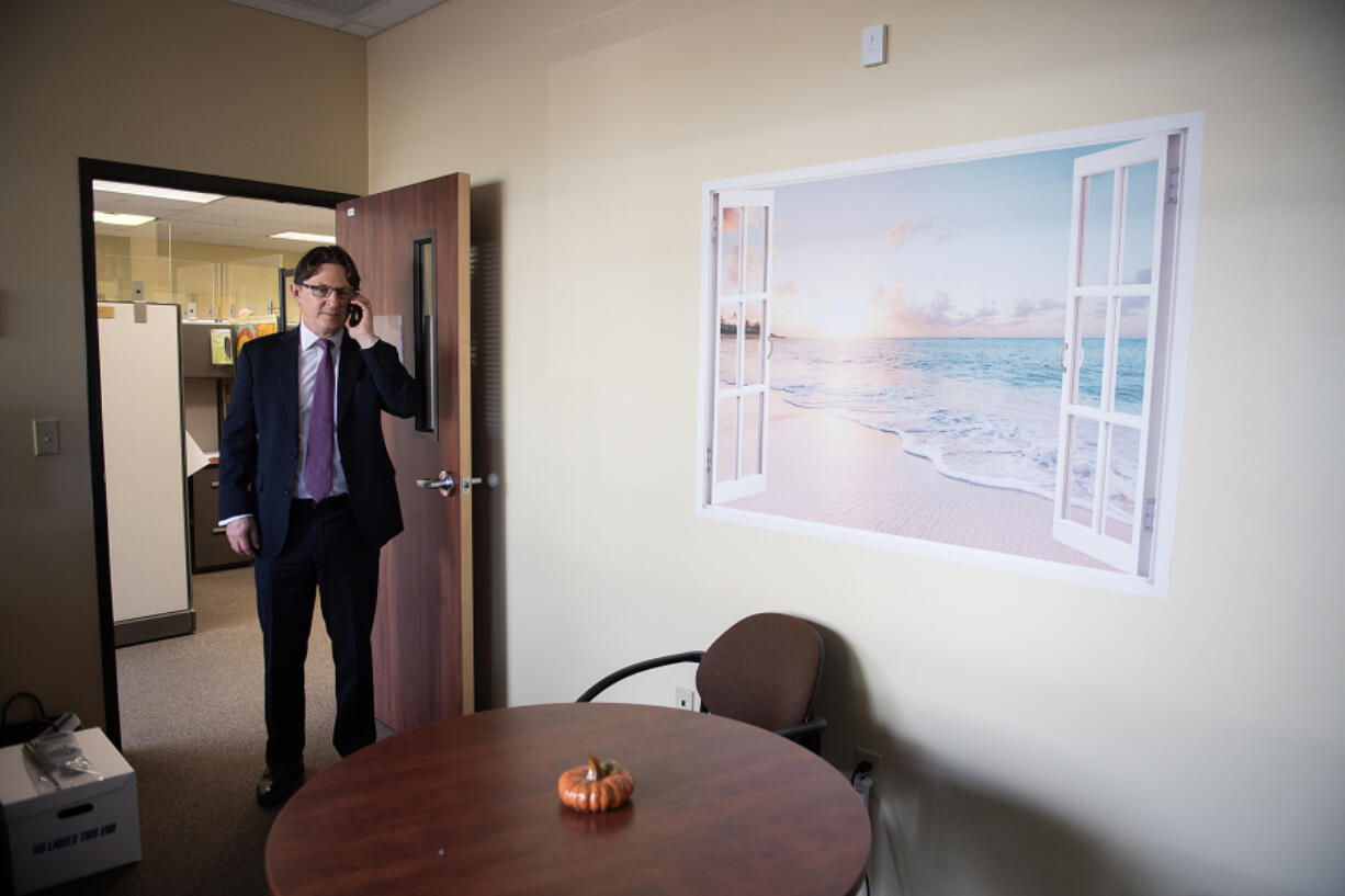 Ben Veghte, director of WA Cares, Washington&rsquo;s long-term health care program, takes a call at the Area Agency on Aging and Disabilities of Southwest Washington office on Monday. Veghte will speak at a conference on Tuesday morning in Vancouver hosted by Alzheimer&rsquo;s Association.