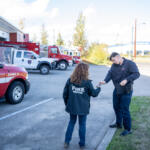 Firefighter-paramedic Connor Danielson hands car keys to mental health professional Janie Wadiak on Wednesday, while Danielson takes a call at Clark-Cowlitz Fire Rescue Station 21 in Ridgefield. The pair work as part of the Clark-Cowlitz Cares Team that can respond to community members experiencing crises. (Taylor Balkom/The Columbian)