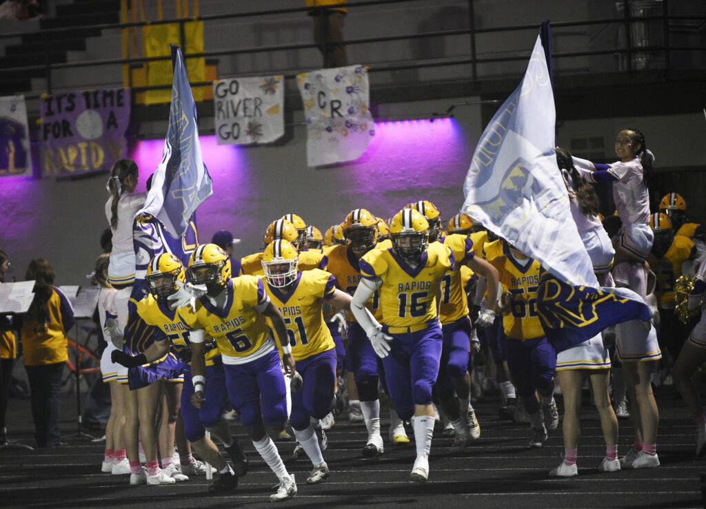 Columbia River players run onto the field prior to their 2A Greater St. Helens League football game against Hockinson at Columbia River High School on Friday, Oct. 11, 2024.