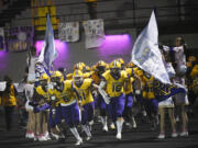 Columbia River players run onto the field prior to their 2A Greater St. Helens League football game against Hockinson at Columbia River High School on Friday, Oct. 11, 2024.