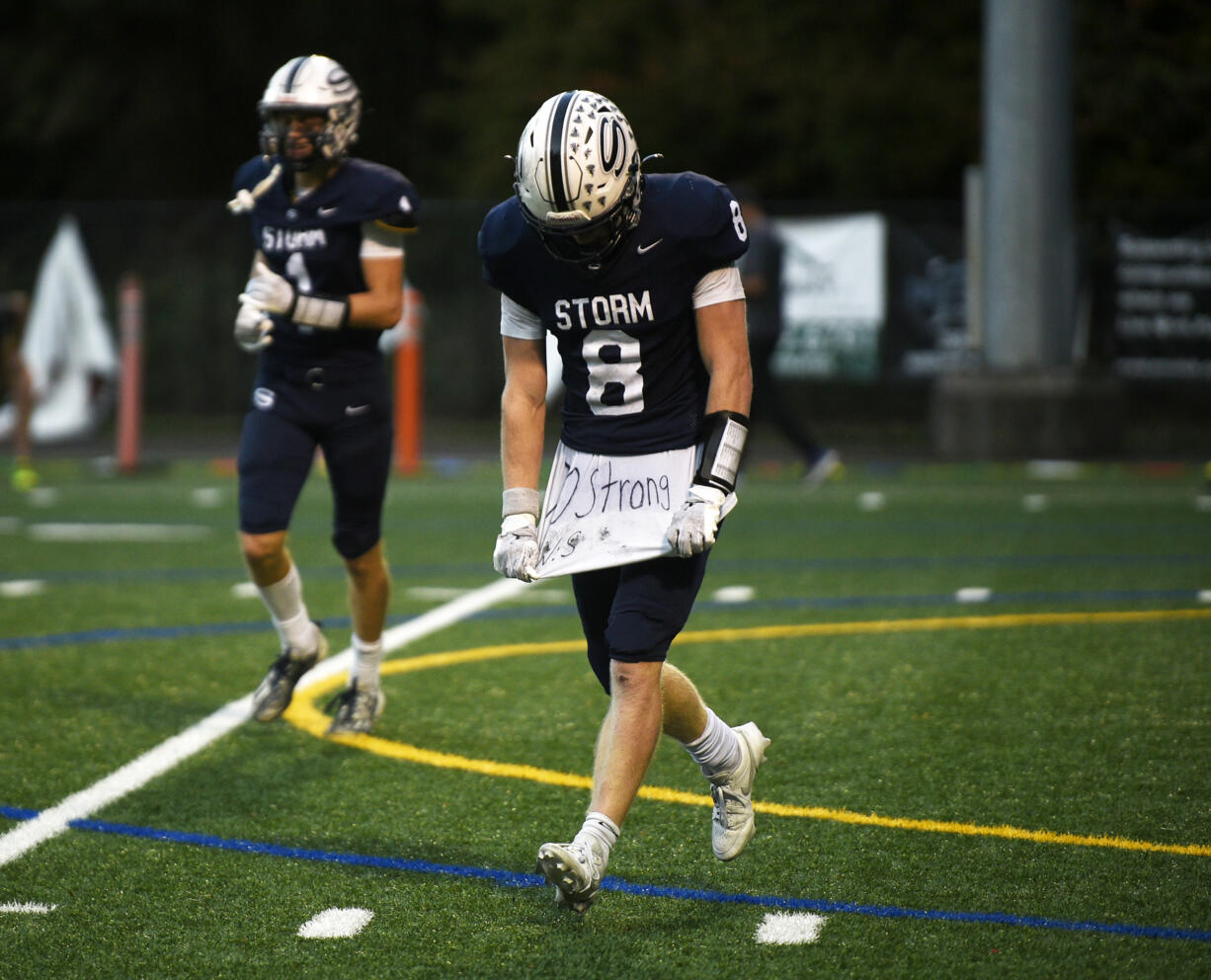 Gavin Packer (8) of Skyview displays his undershirt with the inscription "70 strong W.S." for his late teammate William Sloan. Packer scored the go-ahead touchdown as the Storm beat Richland 21-14 in a non-league football game at Kiggins Bowl on Saturday, Oct. 12, 2024.