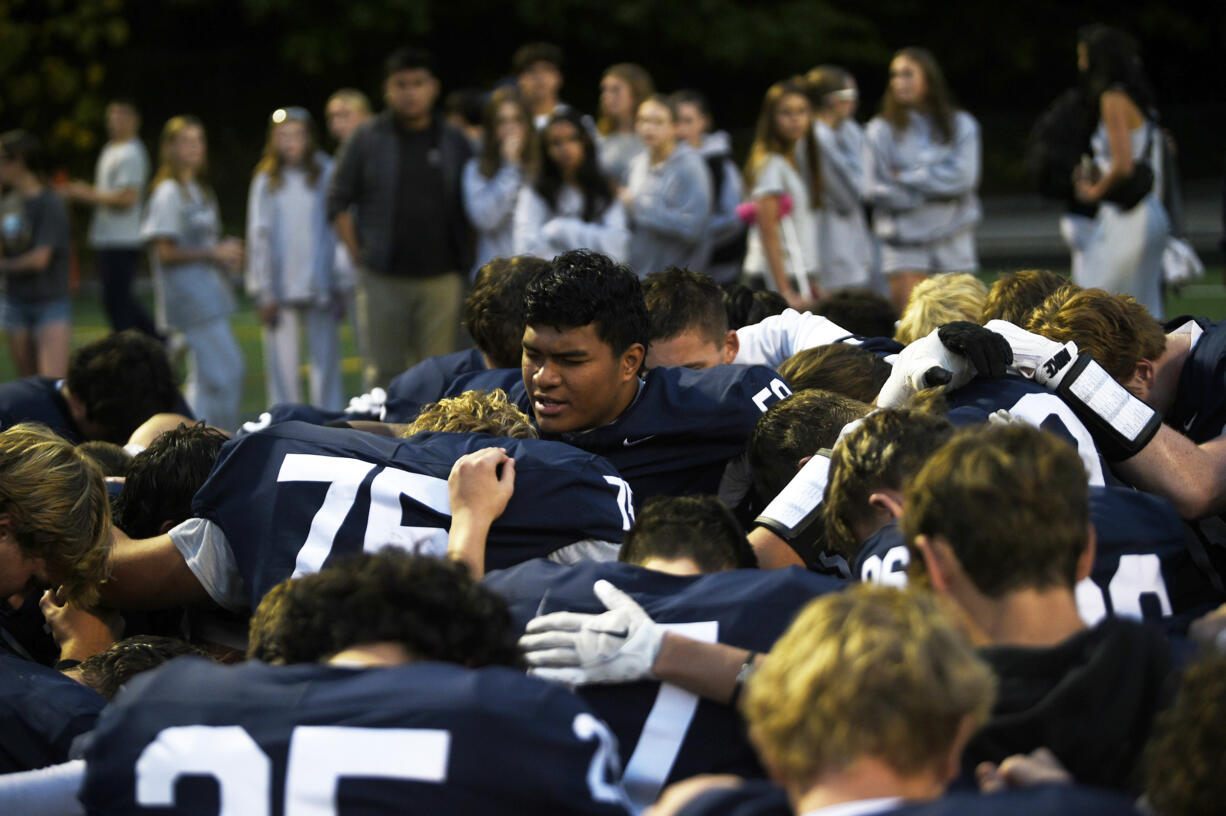 Riah Tua leads the Skyview football team in a post-game prayer after the Storm beat Richland 21-14 in a non-league football game at Kiggins Bowl on Saturday, Oct. 12, 2024.