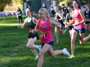 Lyla Taylor of Hockinson (1371) and Kaylynn McSmith of Woodland lead the pack at the start of the girls race at a 2A Greater St. Helens League cross country meet at Hockinson Meadows Park on Wednesday, Oct. 9, 2024.