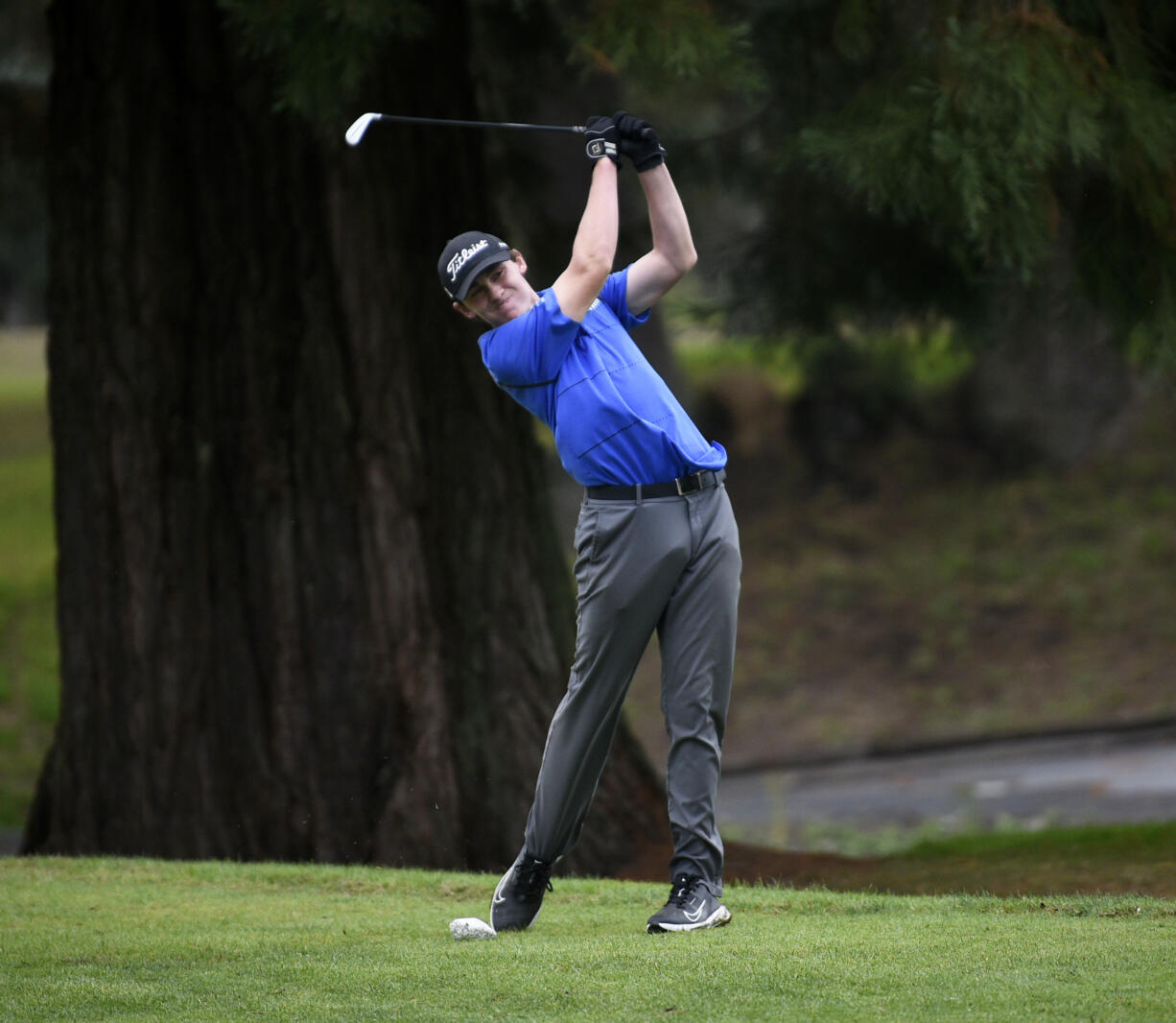 Grady Millar of Mountain View hits a tee shot on the No. 14 hole at Lewis River Golf Course during the 3A district boys golf tournament on Tuesday, Oct. 15, 2024.