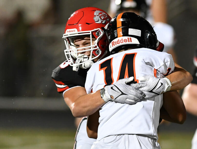 Camas senior Nikko Speer, left, tackles Battle Ground junior Dominick Rivas Friday, Oct. 18, 2024, during the Papermakers’ 63-7 win against Battle Ground at Doc Harris Stadium in Camas.