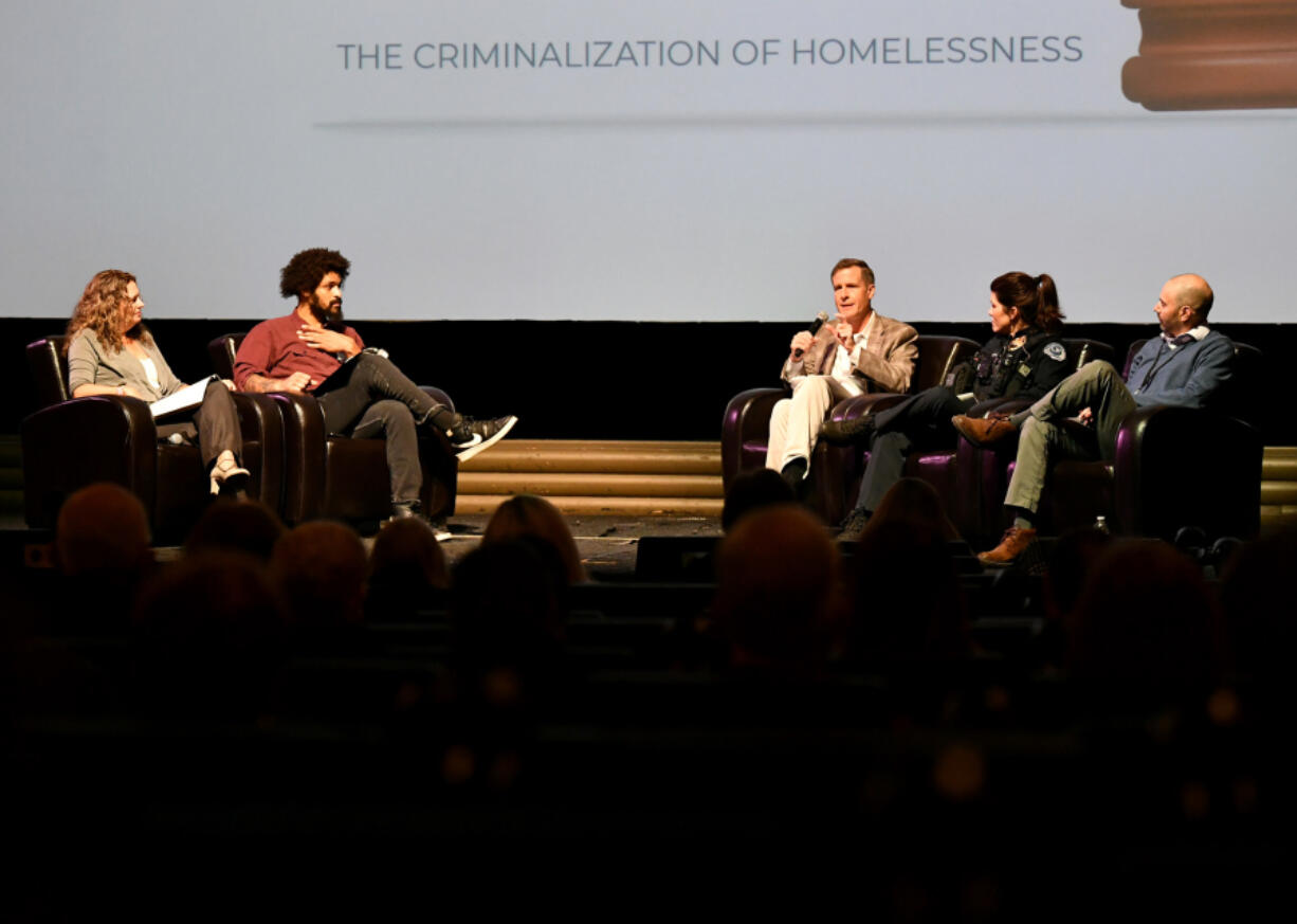 *LEADOPTION* Moderators Amy Reynolds, from left, and Britton Brown listen as Oregon Law Center Director of Litigation Ed Johnson speaks on a panel with  Vancouver Police Department Assistant Chief Erika Nilsen and Vancouver Housing Authority CEO Andy Silver.