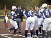 Skyview players greet Nivayah Henry, left, at home plate following a home run hit by the junior in the Class 4A district slowpitch softball championship against Union on Wednesday, Oct. 16, 2024, at Evergreen High School.