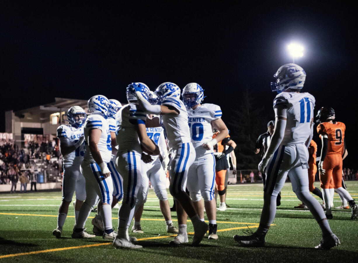 La Center players swarm senior Wyatt Eiesland (5) after a touchdown Friday during La Center&rsquo;s 41-6 win against Kalama at Kalama High School.