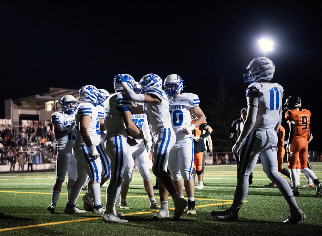 La Center players swarm senior Wyatt Eiesland (5) after a touchdown Friday, Oct. 25, 2024, during La Center’s 41-6 win against Kalama at Kalama High School.