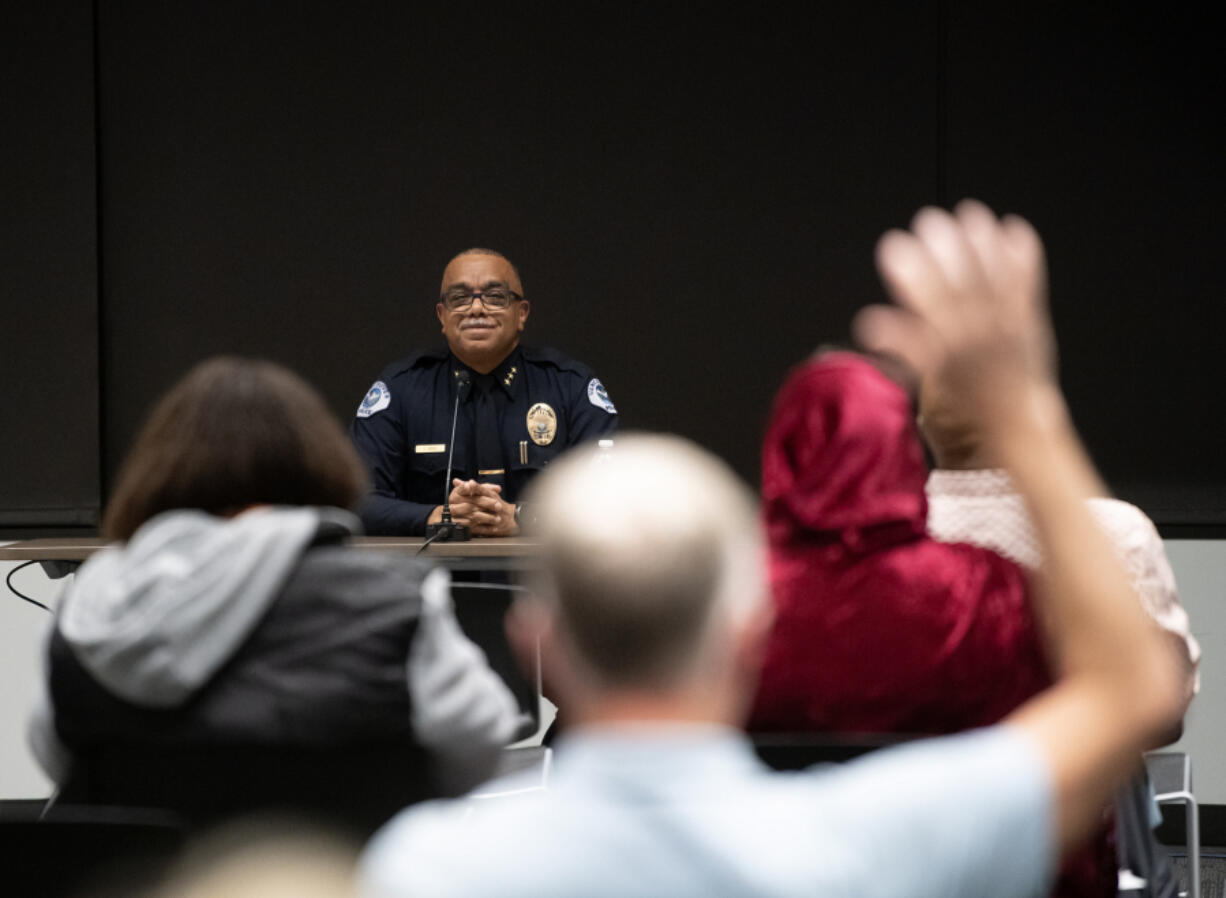 An audience member raises his hand as Interim Vancouver Police Chief Troy Price listens to a question Wednesday during a forum at Evergreen Public Schools Administrative Service Center. Price is the only finalist to take over as chief for Vancouver police.