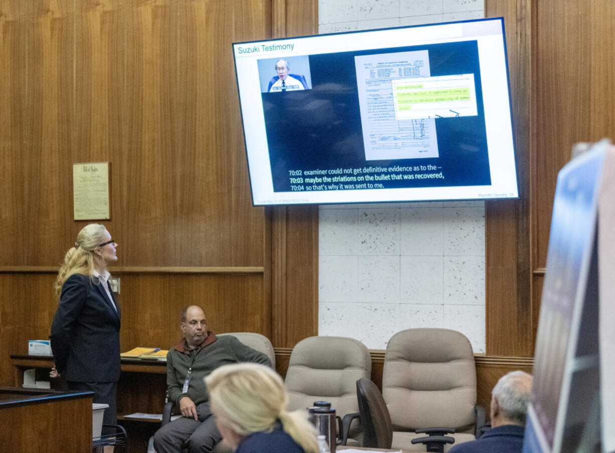 Attorney Renee Rothauge, left, shows a video clip to jurors Monday during the wrongful death trial filed by the family of Effie Entezari, who was killed in 1989. She promised to show the jury evidence that the defendant in the suit, Viktor Pell, was responsible for Entezari&rsquo;s death, despite the woman&rsquo;s estranged husband being convicted of the crime and serving 16 years in prison.