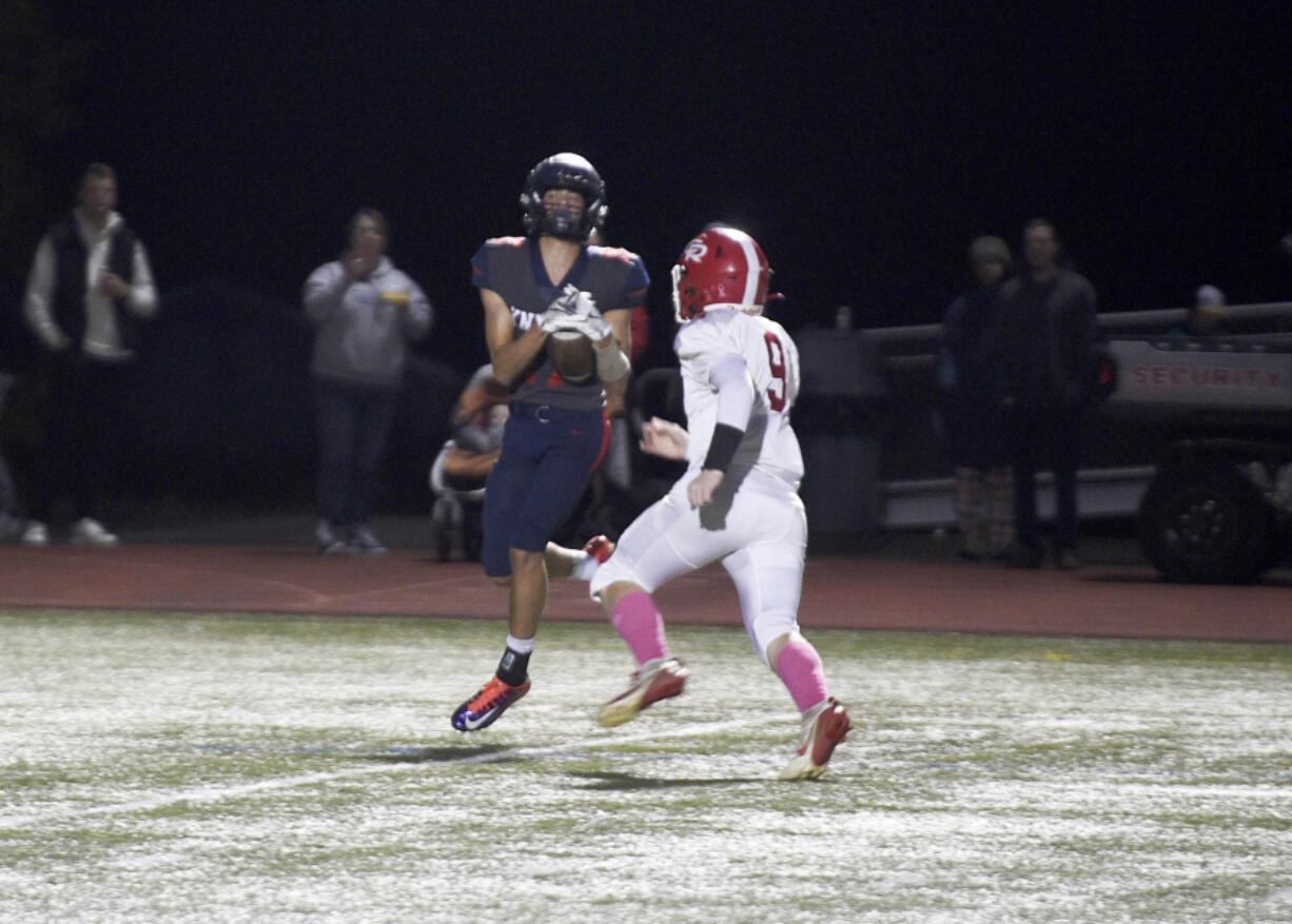 King&rsquo;s Way Christian receiver Caleb Silva hauls in a 51-yard touchdown pass in front of Castle Rock defender John Soden during a Class 1A Trico League football game on Friday, Oct. 25, 2024 in Vancouver.