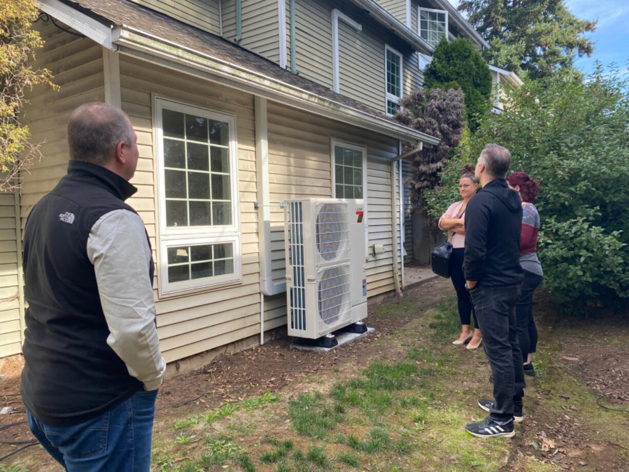 Second Step Housing staff examine the outdoor compressors for new ductless heat pumps. Clark Public Utilities&rsquo; new Community Grant Program recently awarded $120,000 to Vancouver nonprofit Second Step Housing for new ductless heat pumps.