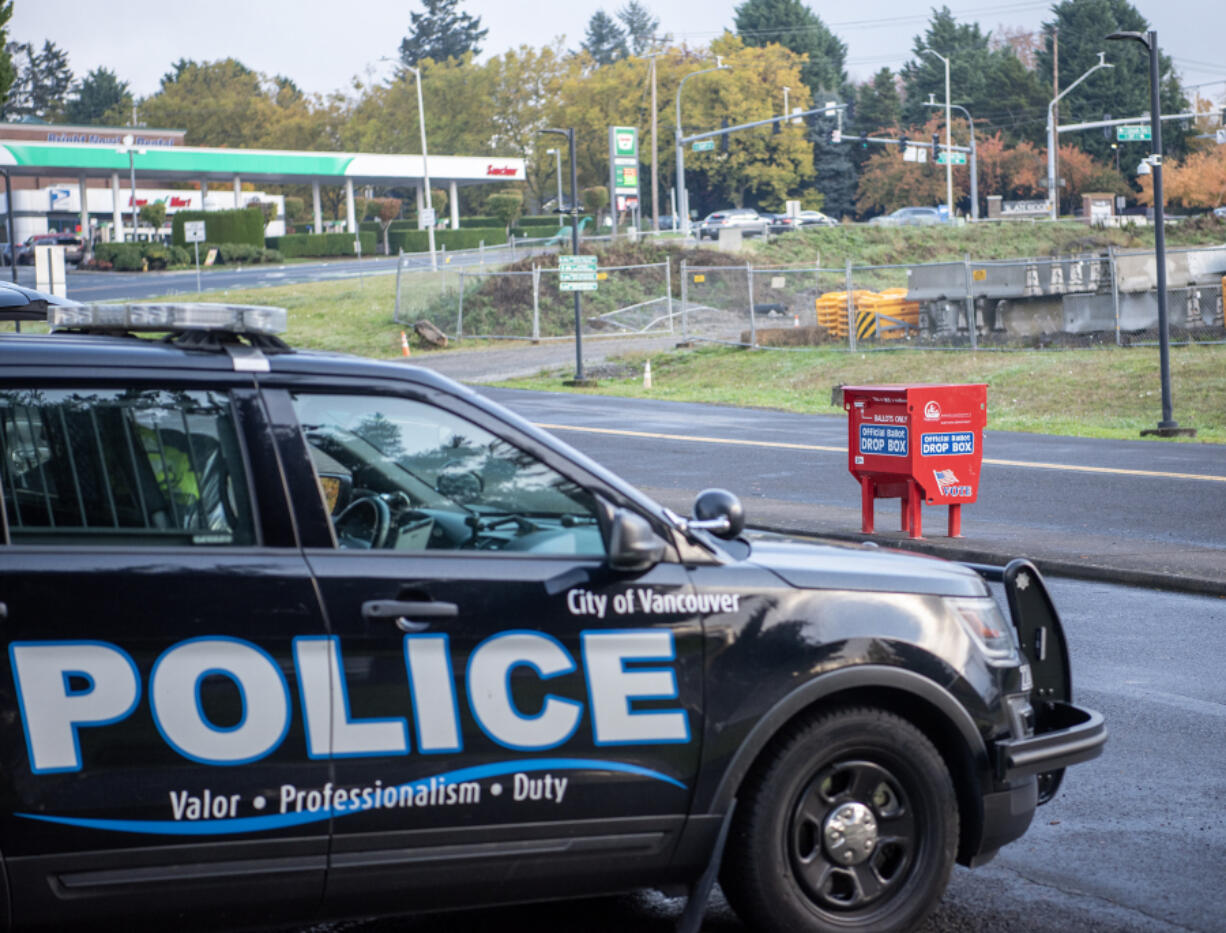 Taylor Balkom/The Columbian
A Vancouver police cruiser sits in a parking lot Tuesday near the Fisher&rsquo;s Landing Transit Center ballot box following an attack on the box that destroyed hundreds of ballots Monday morning.