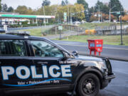 Taylor Balkom/The Columbian
A Vancouver police cruiser sits in a parking lot Tuesday near the Fisher&rsquo;s Landing Transit Center ballot box following an attack on the box that destroyed hundreds of ballots Monday morning.