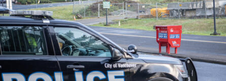 Taylor Balkom/The Columbian
A Vancouver police cruiser sits in a parking lot Tuesday near the Fisher&rsquo;s Landing Transit Center ballot box following an attack on the box that destroyed hundreds of ballots Monday morning.