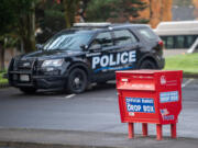 Taylor Balkom/The Columbian
A Vancouver police cruiser near a ballot box Tuesday in Fisher&rsquo;s Landing. The Clark County Auditor&rsquo;s Office announced ballot boxes would be staffed with observers 24/7 until the end of the election after boxes in Vancouver and Portland, including the Fisher&rsquo;s Landing Transit Center ballot box were targeted by arson early Monday morning.