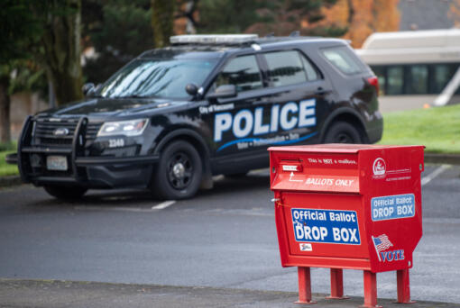 Taylor Balkom/The Columbian
A Vancouver police cruiser near a ballot box Tuesday in Fisher&rsquo;s Landing. The Clark County Auditor&rsquo;s Office announced ballot boxes would be staffed with observers 24/7 until the end of the election after boxes in Vancouver and Portland, including the Fisher&rsquo;s Landing Transit Center ballot box were targeted by arson early Monday morning.