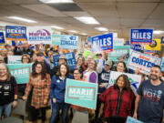 Volunteers and candidates pose for a photo at a Get Out The Vote event hosted the by Washington State Democratic Party on Thursday at the Laborers Local 335 hall in Vancouver.