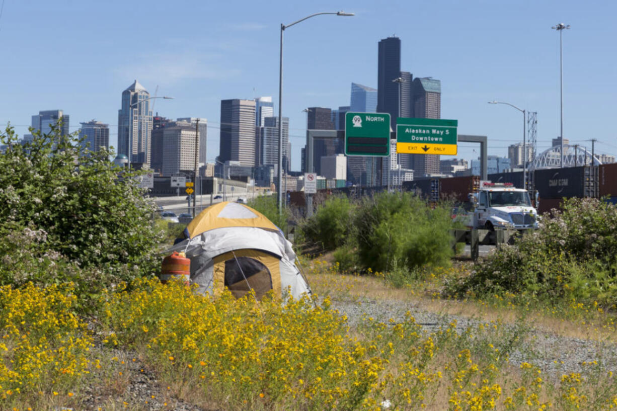 The state Department of Commerce released its five-year Homeless Housing Strategic Plan. A lone tent is pitched between E Marginal Way S and Highway 99 in the Industrial District in this June 11, 2019 file photo.