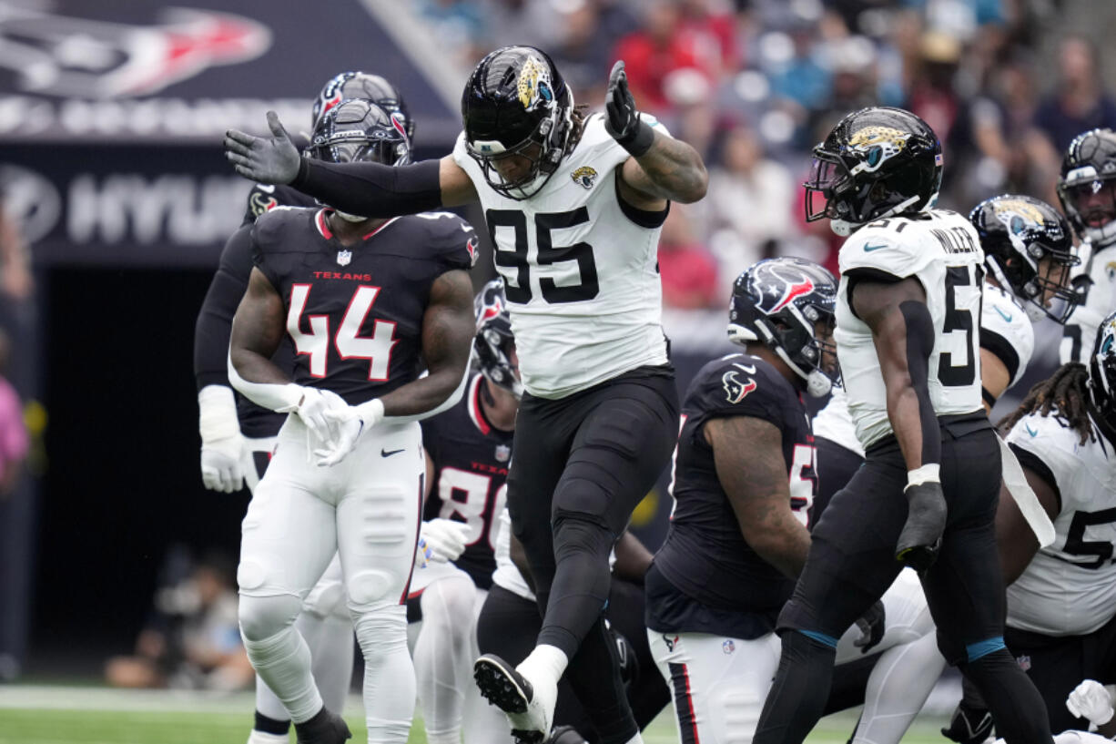 Jacksonville Jaguars defensive tackle Roy Robertson-Harris (95) celebrates after making a tackle during the first half of an NFL football game against the Houston Texans, Sunday, Sept. 29, 2024, in Houston.