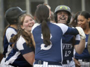 Skyview's Kenzie Lakin (13) is greeted by teammates Jordyn Pagette, left, and Jaslyn Ausmus, center, after hitting a game-tying home run against Union in game one of the Class 4A district slowpitch softball championship series on Wednesday, Oct. 16, 2024, at Evergreen High School.