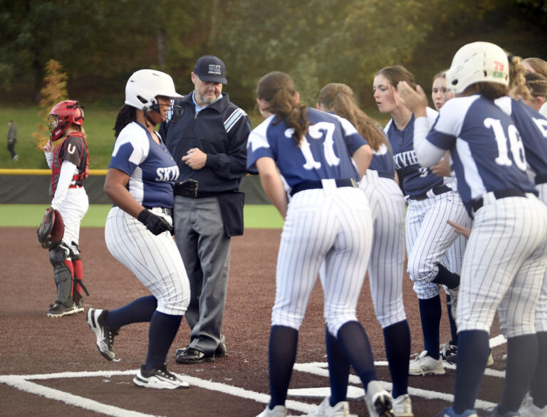 Skyview players greet Nivayah Henry, left, at home plate following a home run hit by the junior in the Class 4A district slowpitch softball championship against Union on Wednesday, Oct. 16, 2024, at Evergreen High School.