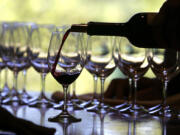 A worker at St. Supery winery pours a glass of wine for a tasting Sept. 20, 2006, in Rutherford, Calif.