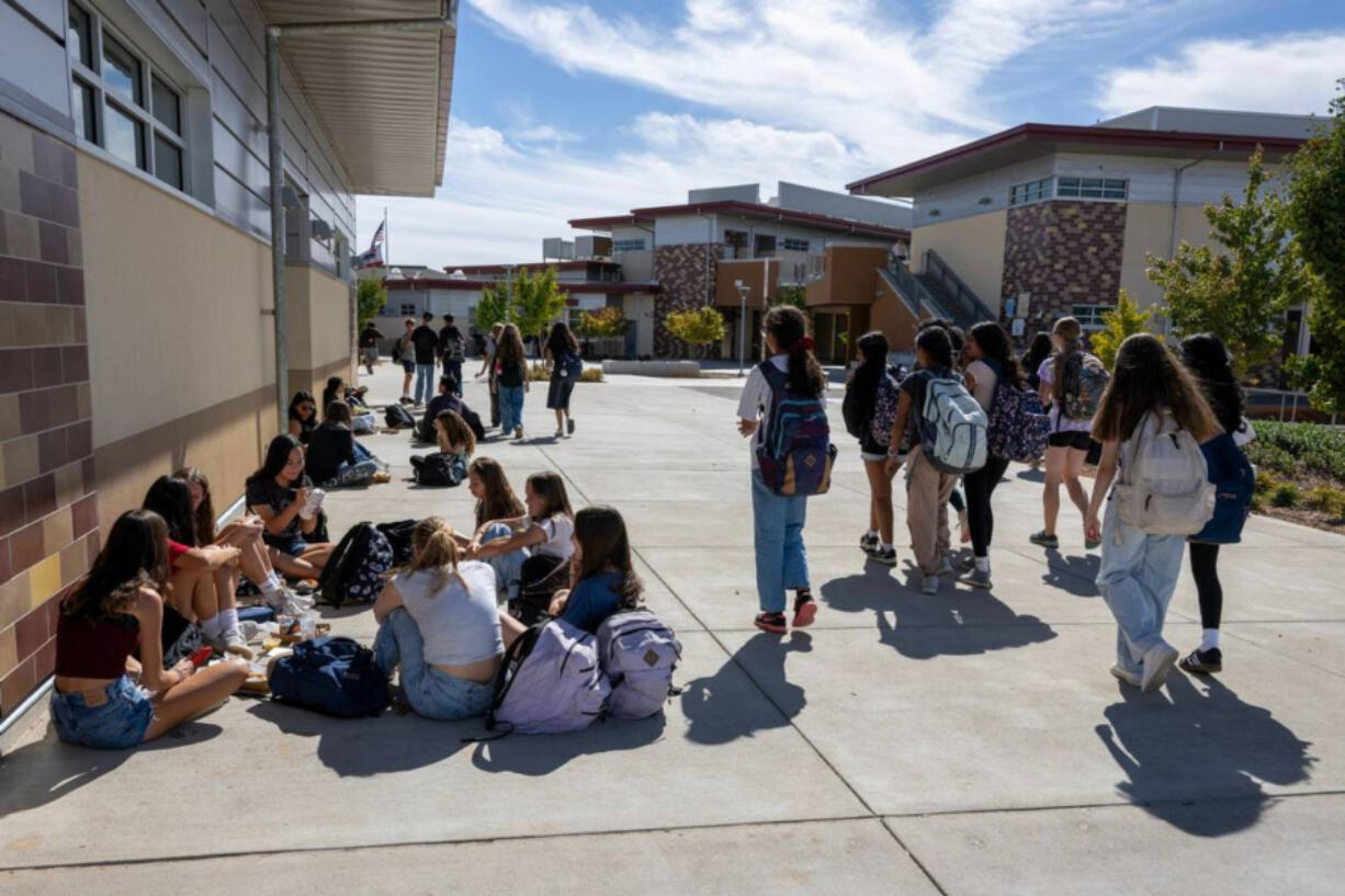 Students socialize during lunch at Sutter Middle School in Folsom on Thursday. The school has banned cell phones during school hours, including lunch, since 2022.