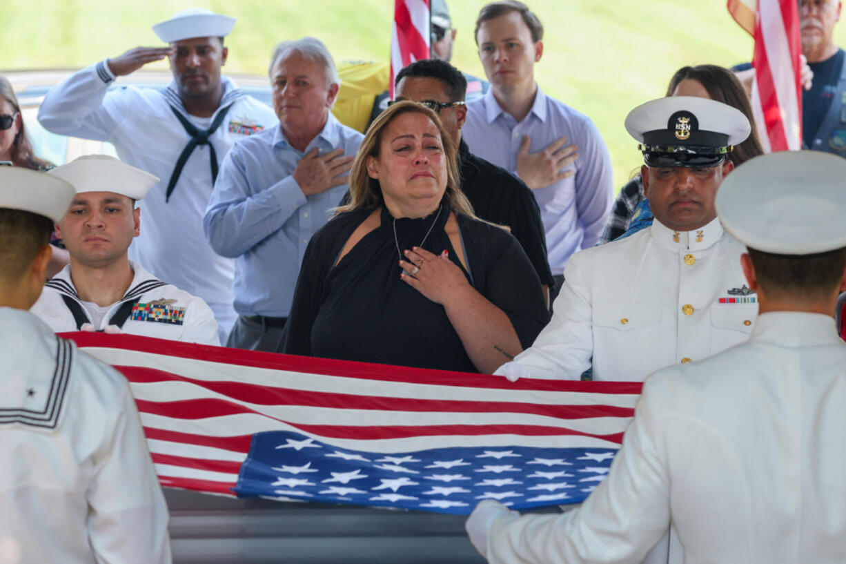 April McKinnon weeps as her great-granduncle, Everett Titterington, is memorialized before his burial at Riverside National Cemetery.