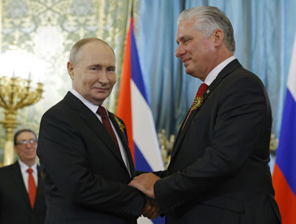 Russia's President Vladimir Putin meets with Cuban President Miguel Diaz-Canel on the sidelines of Victory Day celebrations in Moscow on May 9, 2024.