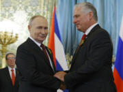 Russia's President Vladimir Putin meets with Cuban President Miguel Diaz-Canel on the sidelines of Victory Day celebrations in Moscow on May 9, 2024.