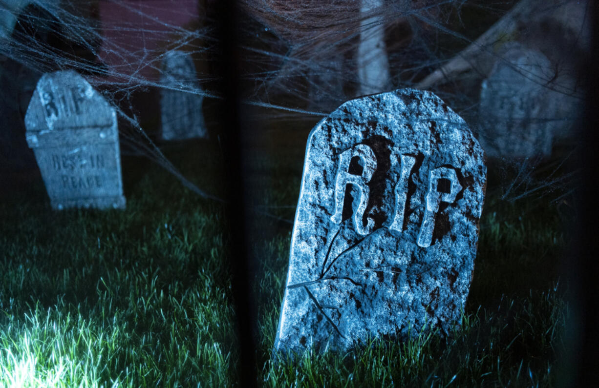 Tombstones sit in the grass Oct. 13, 2021, at Jim Mains&rsquo; house on Franklin Street in Vancouver. Mains&rsquo; upgraded holiday display now stretches across several properties.