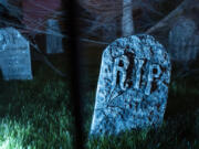 Tombstones sit in the grass Oct. 13, 2021, at Jim Mains&rsquo; house on Franklin Street in Vancouver. Mains&rsquo; upgraded holiday display now stretches across several properties.