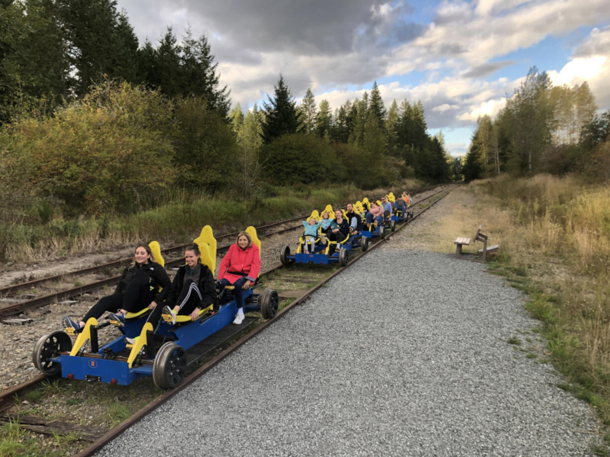 A group on a RailCycle excursion returns after pedaling a little more than 1.5 miles uphill at a 2 percent grade, with guide Frank Amon in the orange reflective vest bringing up the rear to ensure everyone makes it back.