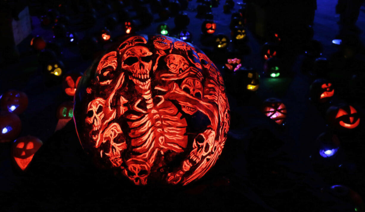 A pumpkin carved and painted with skeletons is displayed at the Rise of the Jack O&rsquo;Lanterns Show, Thursday, Oct. 27, 2016, in Boston.