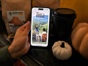 A customer accesses the Columbia Gorge Tourism Alliance&rsquo;s Taste of the Gorge passport at Hidden River Roasters in Camas.