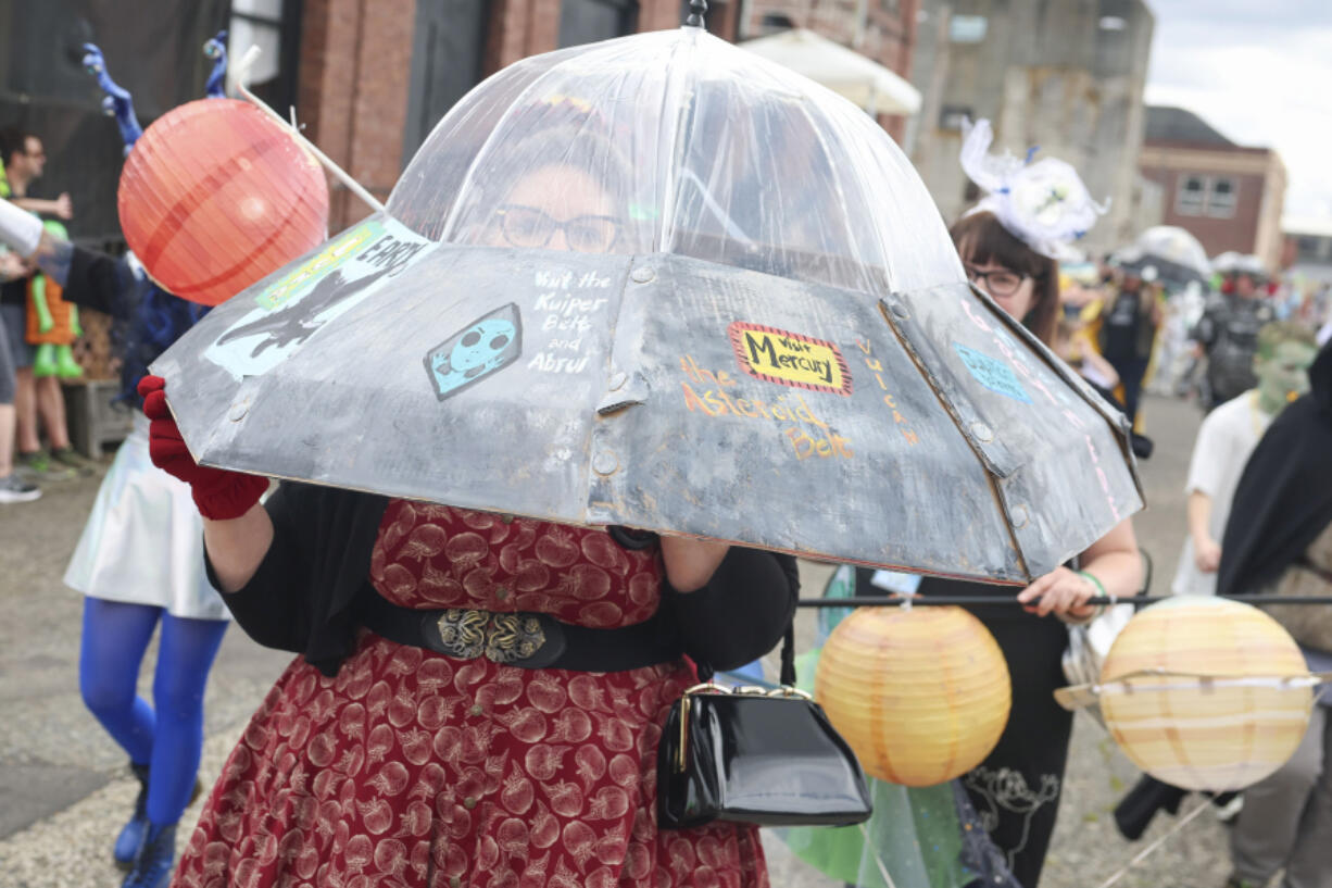 A person wears a flying saucer during a costume parade at the Chehalis Flying Saucer Party on .Sept. 14.